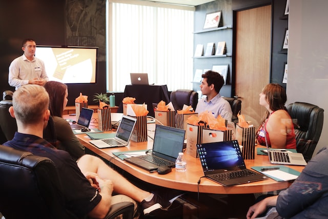 Employees in a board room going through an induction.