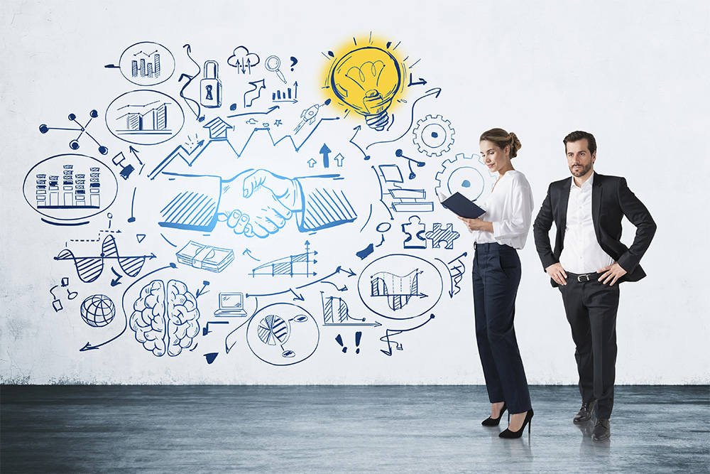 A businesswoman and businessman with a complex graphic representing the complexities in business and the ideas that can come from them.