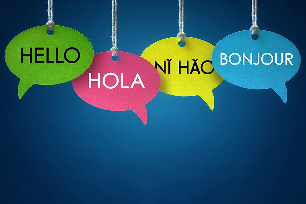 Speech bubbles displaying the words hello, hola, nihao, and bonjour.